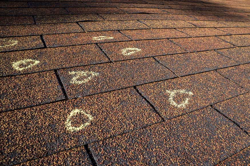 Insurance Adjuster marked hail damage on a insureds roof