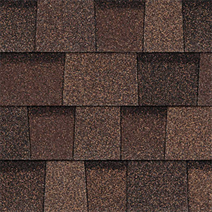 Close-up of red-ish brown architectural shingles with contrasting layered tabs