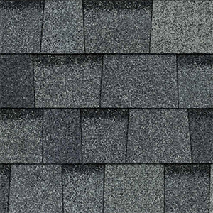 Close-up of grey architectural shingles with contrasting layered tabs