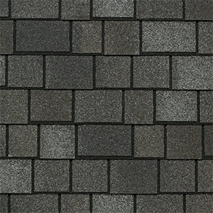 Close-up of grey architectural shingles with contrasting layered tabs