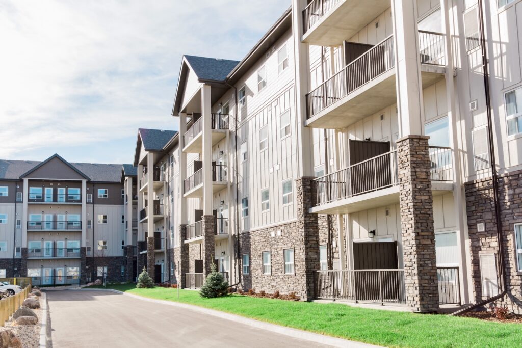 Modern apartment building with balconies, stone accents and light siding